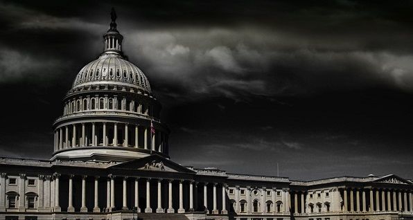 Black and white photo of the Capitol building with a storm brewing in the background.