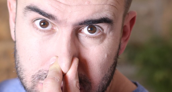 man-holding-nose